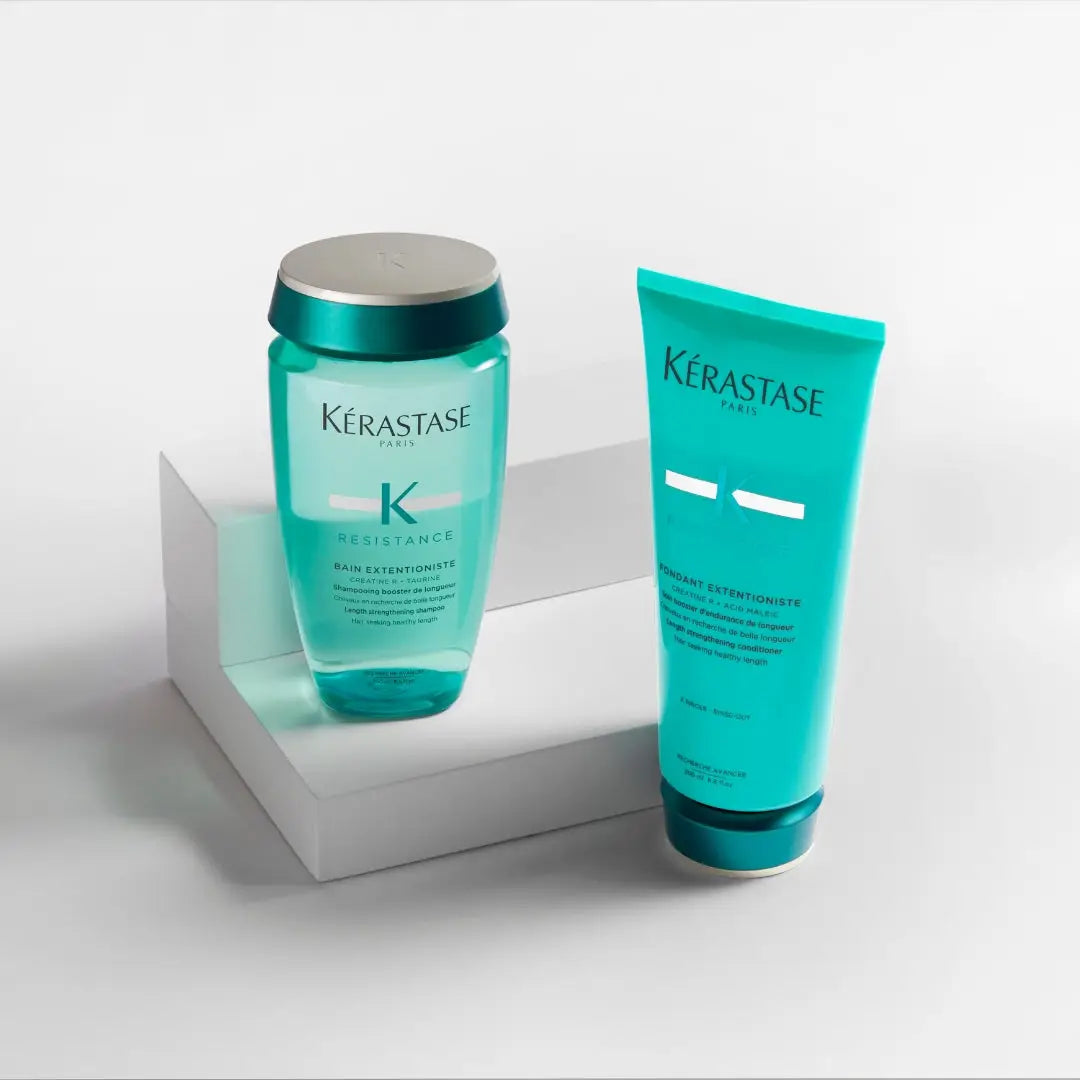 Kérastase Resistance Extentioniste hair care products in teal packaging on white surface