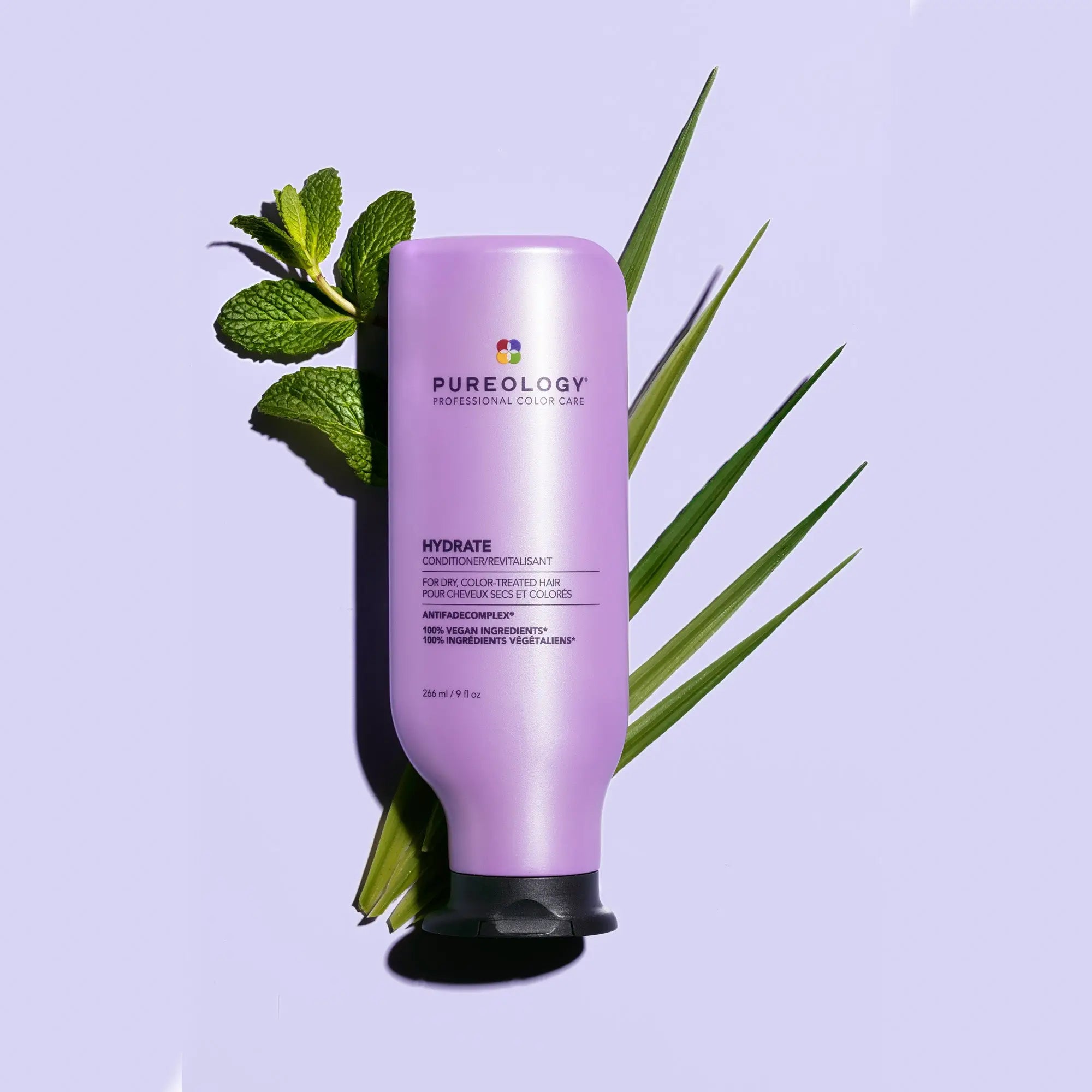 Purple Pureology Hydrate Conditioner with green leaves for healthy hair care.