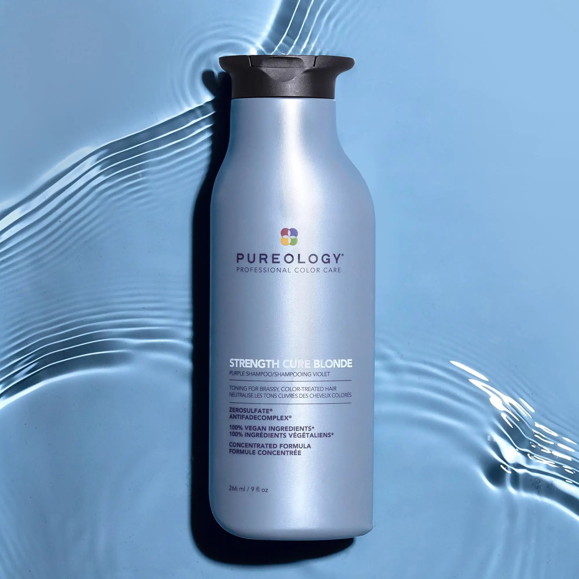 Silver bottle of Pureology Strength Cure shampoo for revitalizing damaged hair