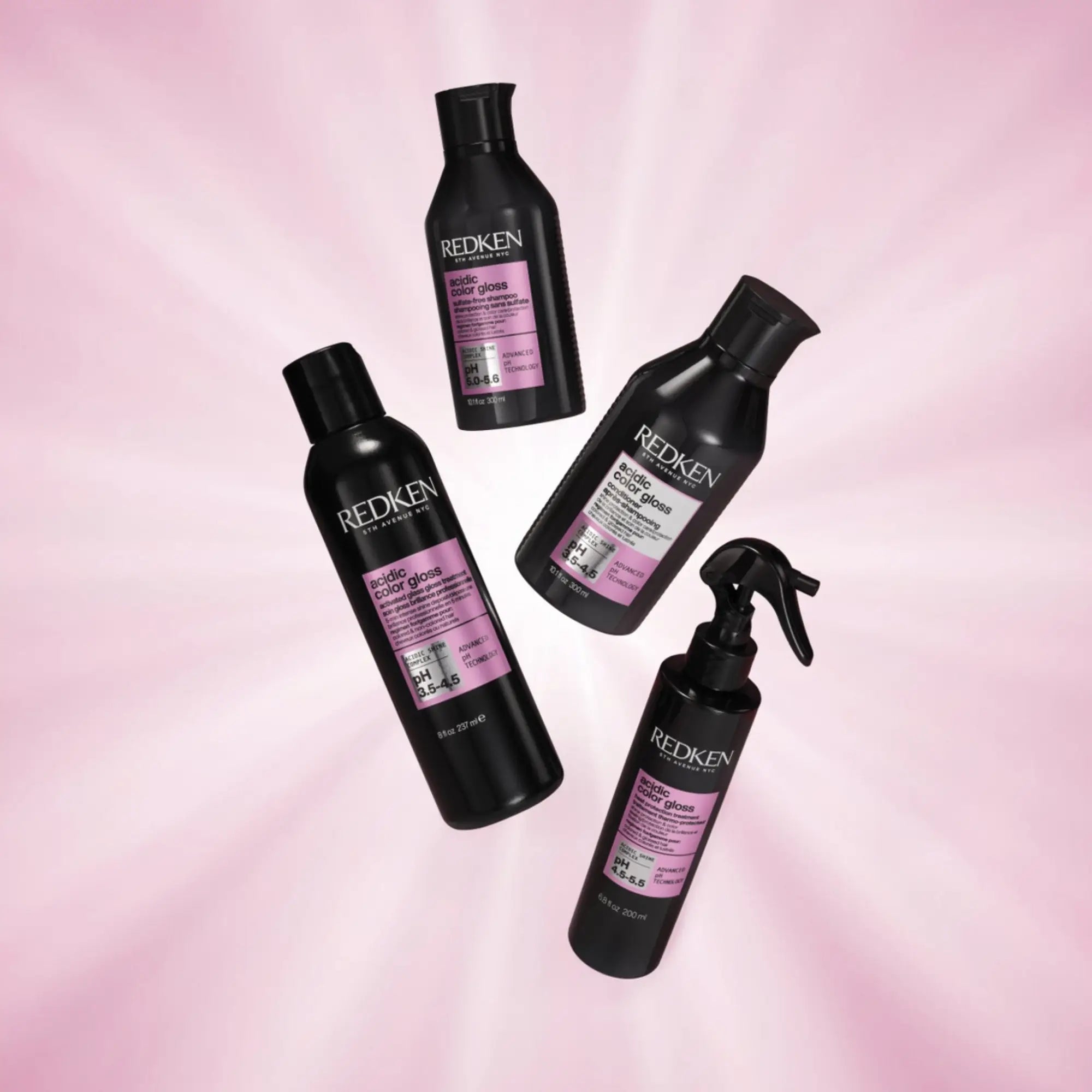 Redken Acidic Color Gloss products in black bottles with pink labels for shiny hair