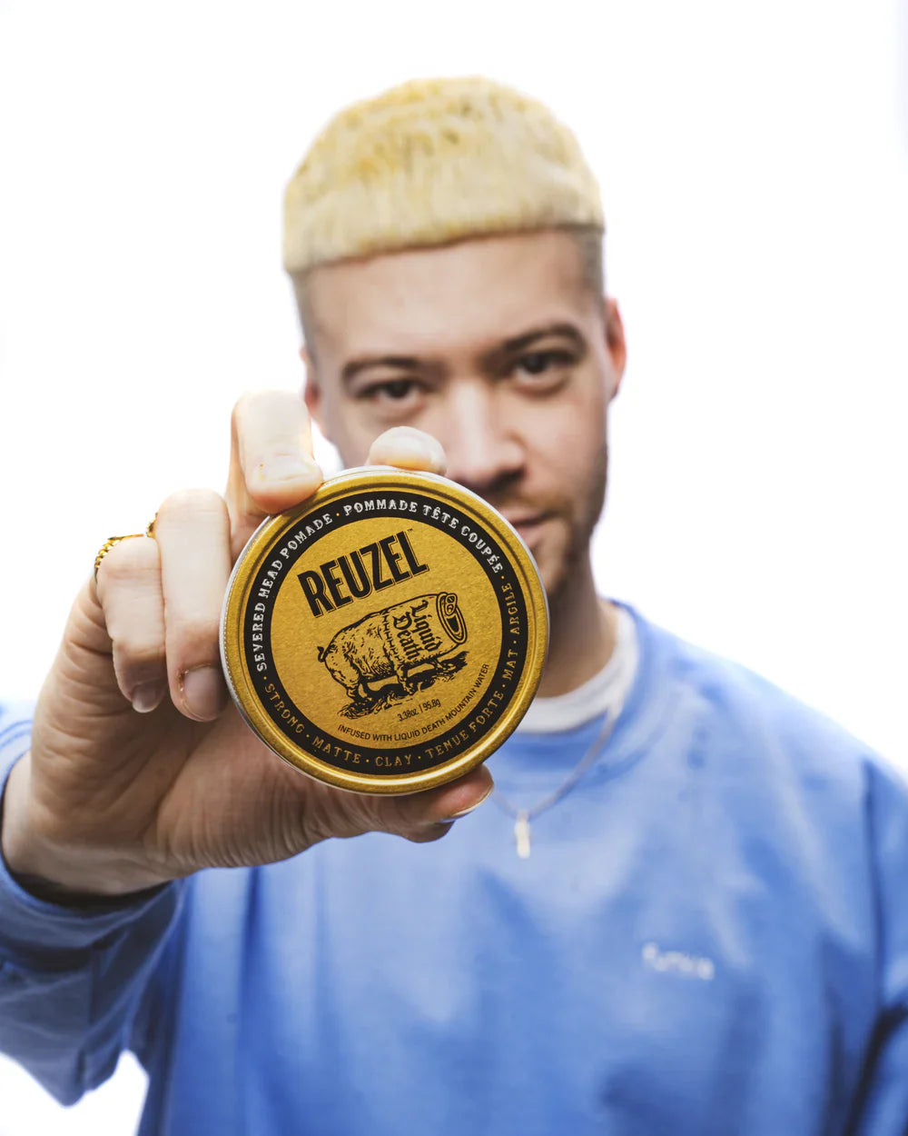 Yellow tin of Reuzel Pomade showcasing its strong hold, a must-have cult classic.