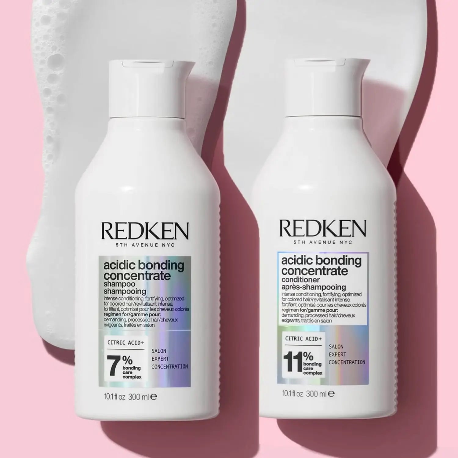 Two white bottles of Redken Acidic Bonding hair products for damaged hair repair.