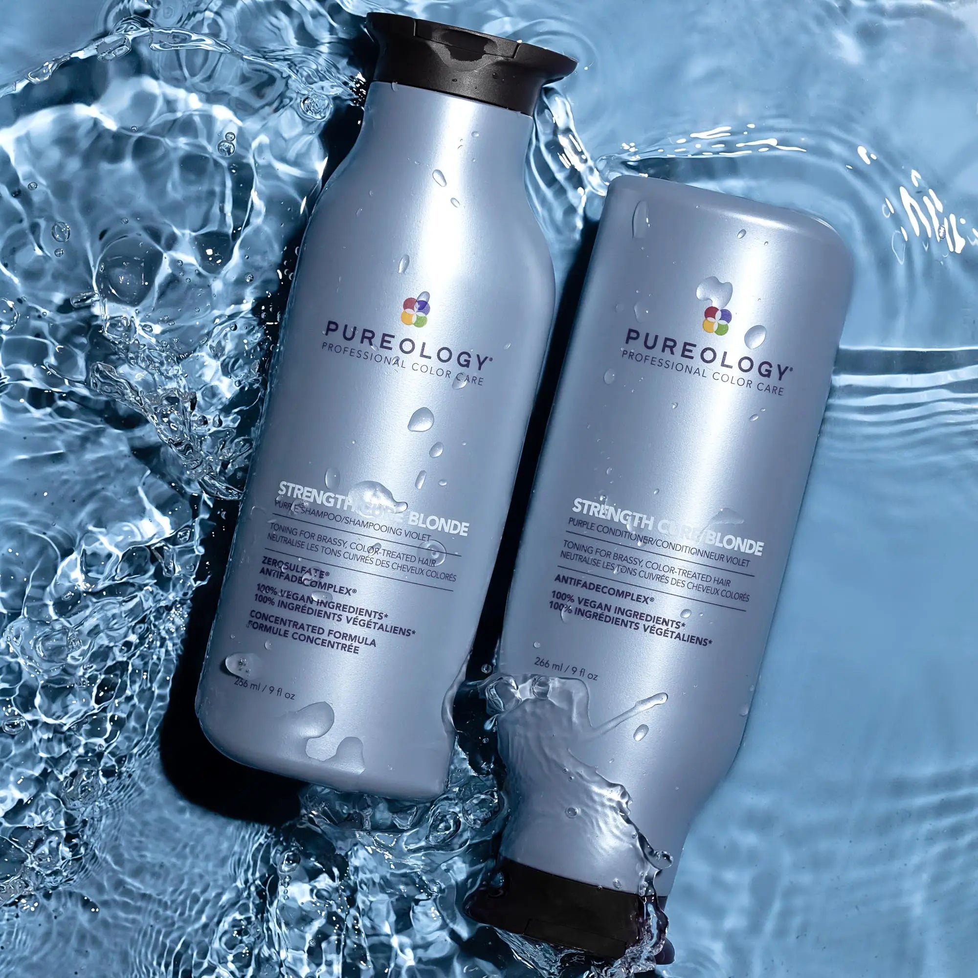 Silver bottles of Pureology sulphate-free conditioners floating in water for hair care.