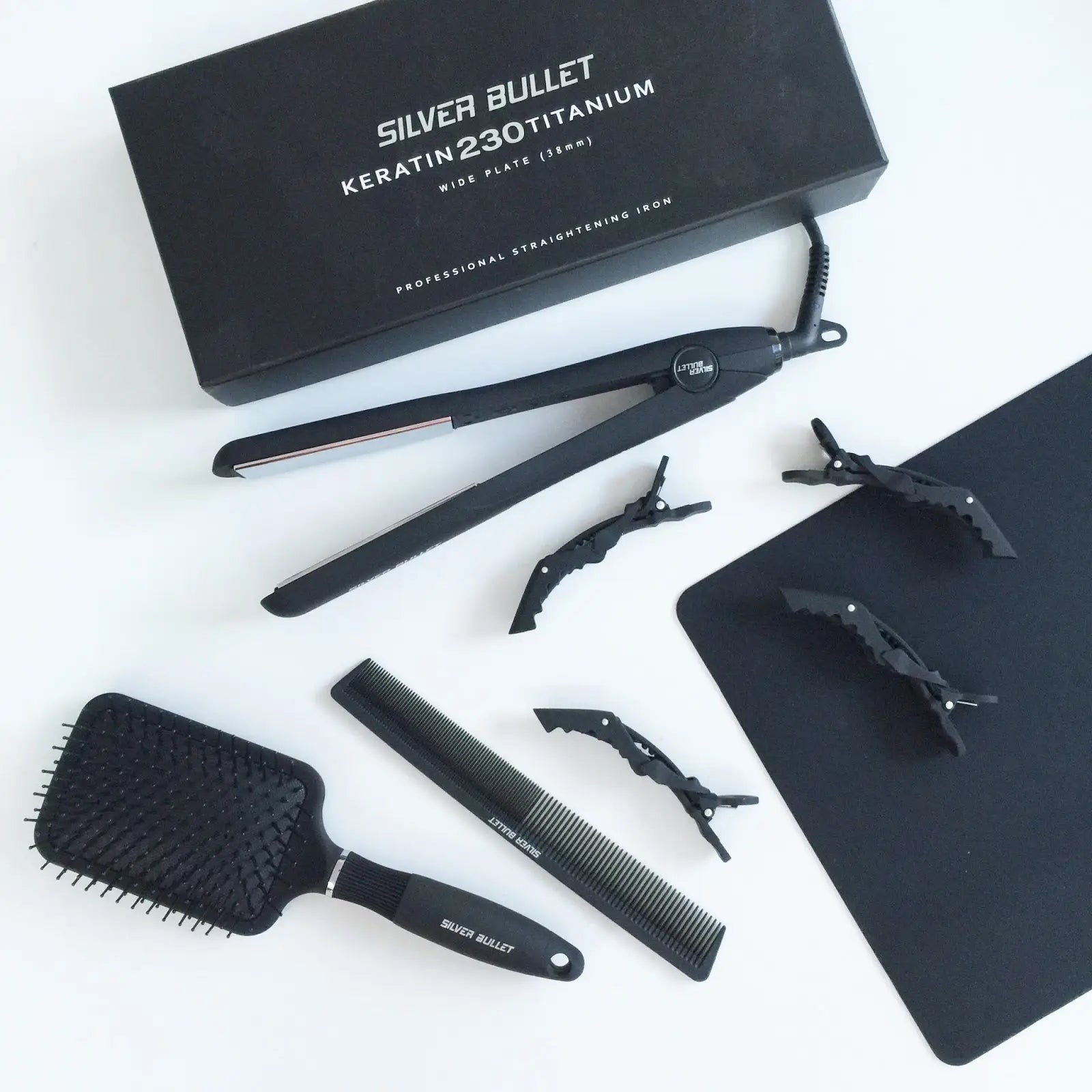 Hair styling kit with Silver Bullet Flat Iron, brushes, combs, and clips for perfect styling.