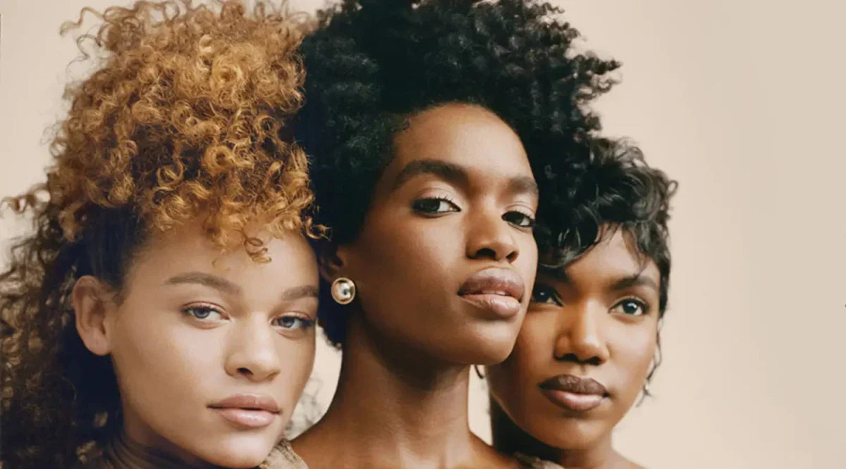 Three women with diverse hairstyles showcasing frizz-free curls and curl definition.