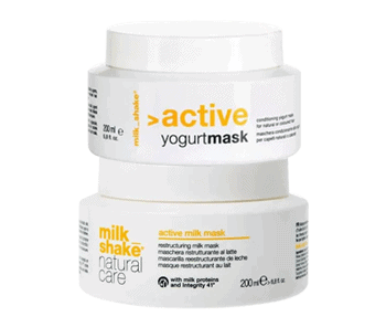 Stacked Milkshake Natural Care hair mask containers on display in a collection