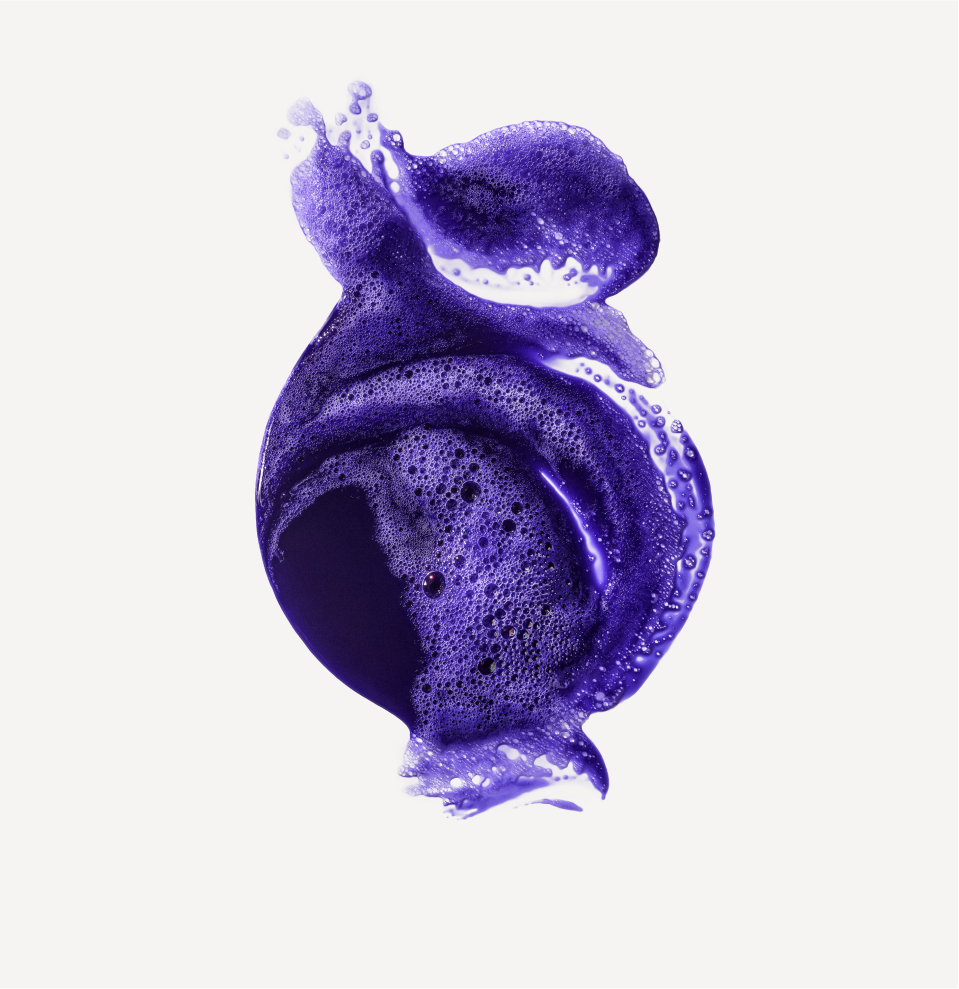Purple foamy liquid splash representing Purple Pigment & Toning Hair Products for blonde and silver hair care