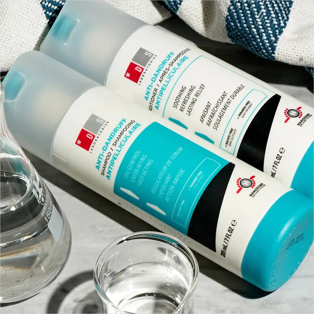 Two DS Laboratories salon quality hair care products in white and teal bottles.