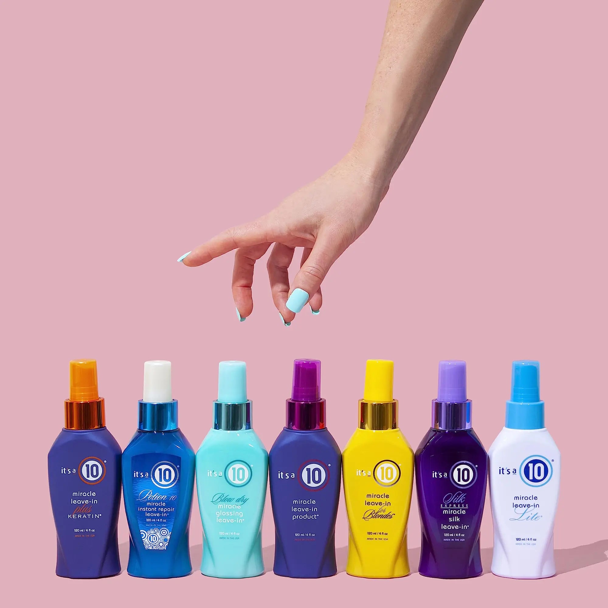 Colorful hair product bottles, including Miracle Coily hair mask 240ml, with a hand reaching.