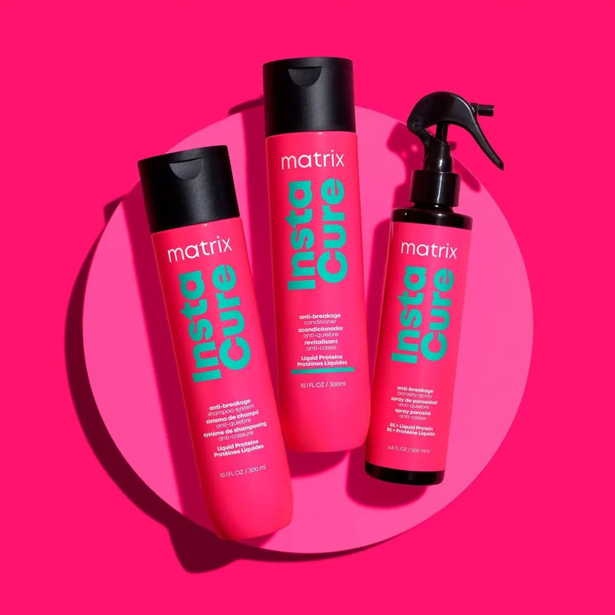 Three Matrix Insta Cure pink hair care product bottles from the Matrix Total Results line.