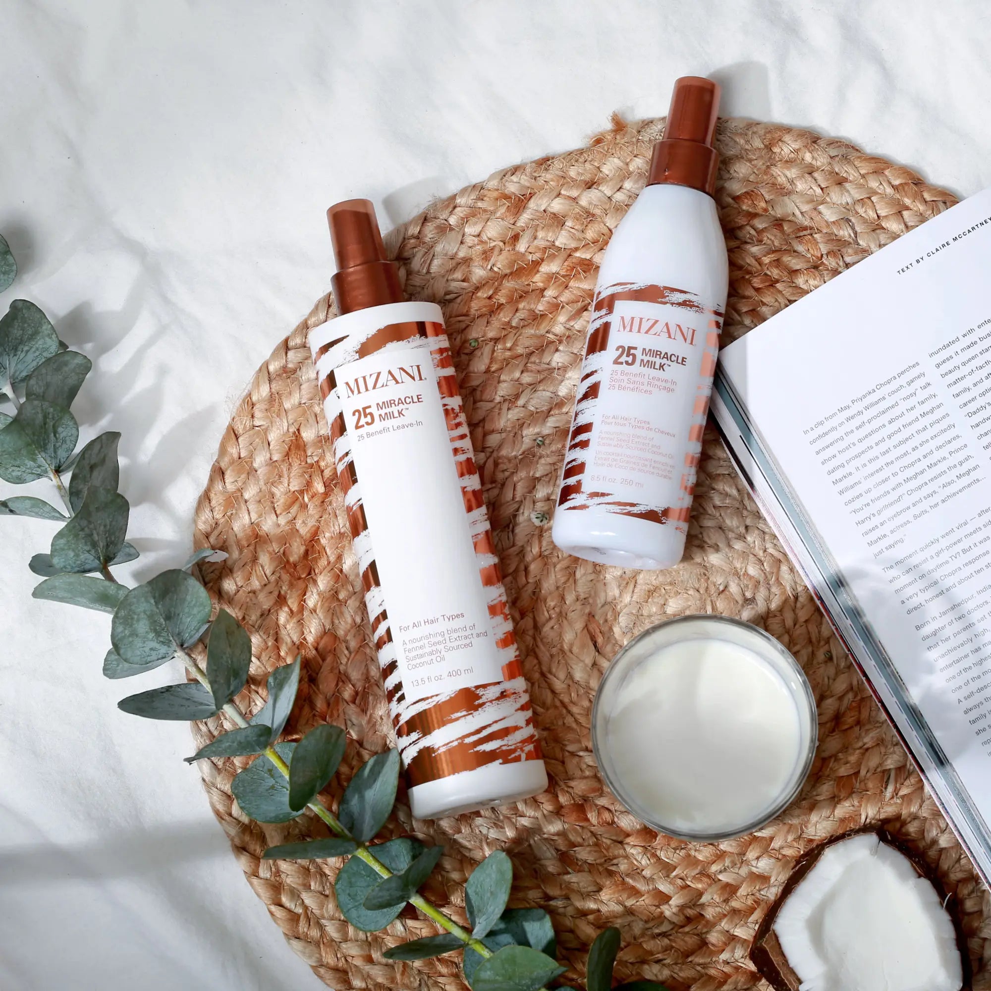 Two bottles of Mizani haircare products for curly hair on a woven circular mat.