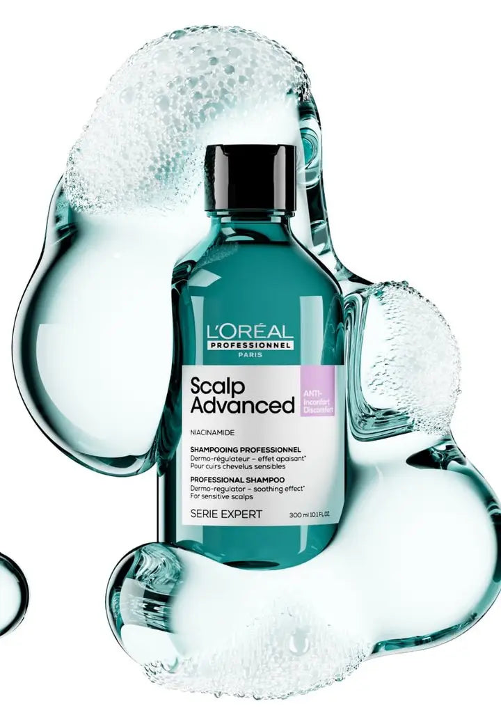 Teal L’Oreal Scalp Advanced shampoo for oily hair with water splashes around it