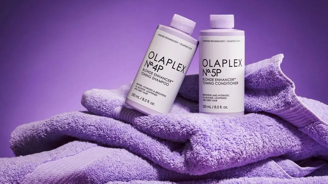 Olaplex hair products: Two bottles on a purple towel in the Olaplex collection.