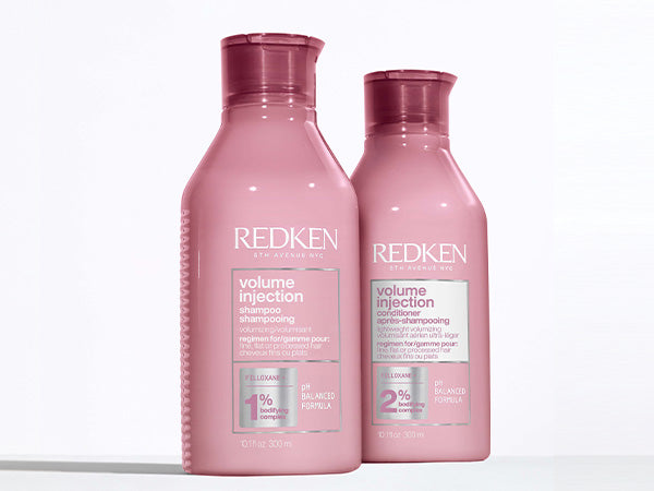 Two pink bottles of Redken Volume Injection shampoo and conditioner in ’Redken Shampoos & Conditioners’.