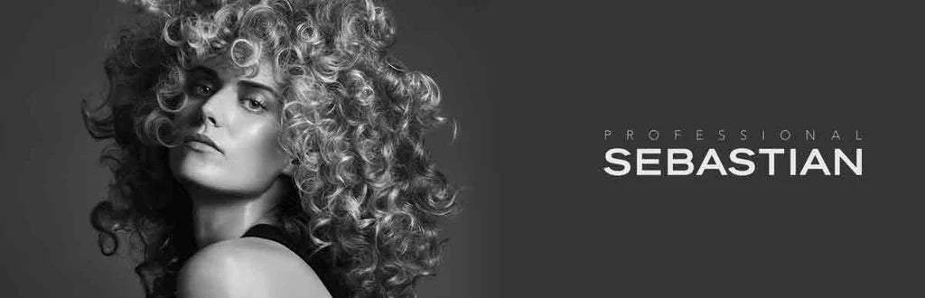 Curly-haired person in dramatic black-and-white portrait from ’Sebastian Professional Sebastian’.