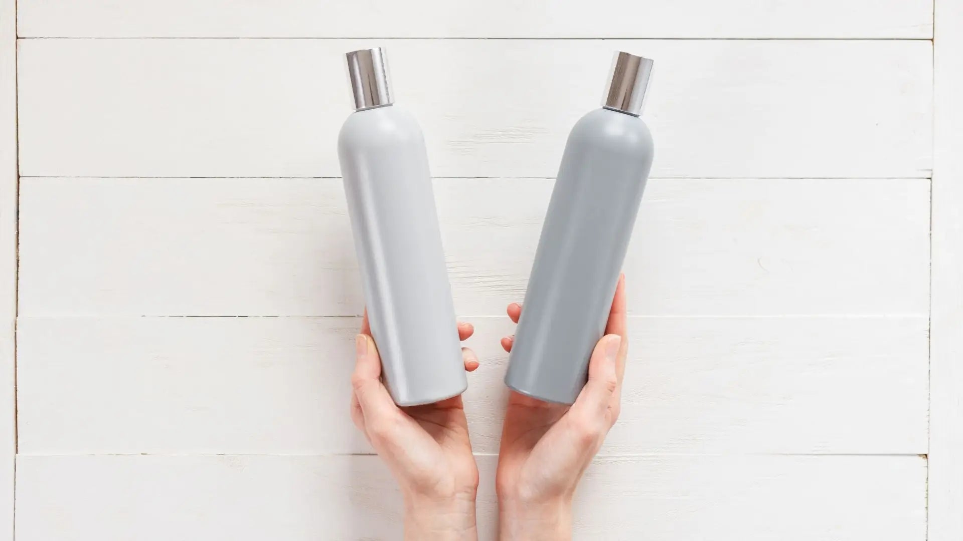 Two white plastic bottles with silver caps from Shampoo Collection 1.