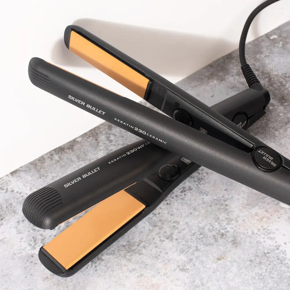 Silver Bullet hair styling tools: Black hair straightener and flat iron with gold ceramic plates.