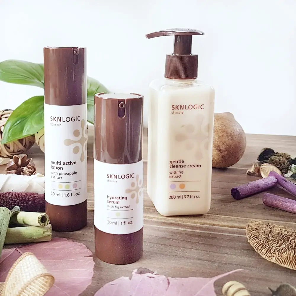 SKNLOGIC skincare product line featuring lotion, serum, and cleansing cream.