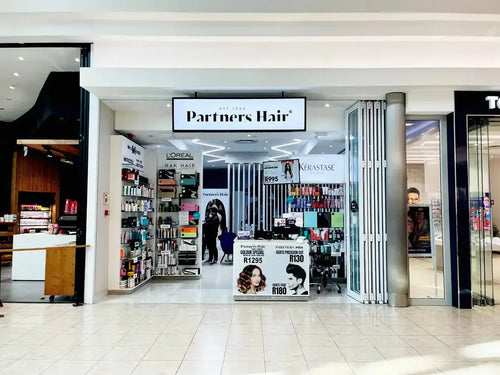 1754555894059-hair-salon-storefront-named-partners-product-displays-visible.webp