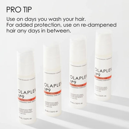 Four white bottles of Olaplex hair product lined up in a row.