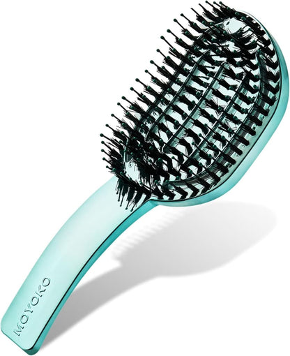 Teal-colored hairbrush with flexible bristles arranged in a curved pattern.