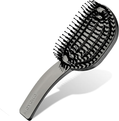 Curved hairbrush with flexible bristles arranged in a spiral pattern.