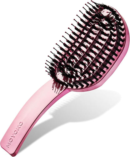 Pink hairbrush with curved bristles arranged in a spiral pattern.