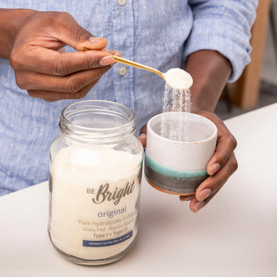 Pouring Be Bright Original Collagen Powder 350g into a cup for easy mixing and optimal absorption.