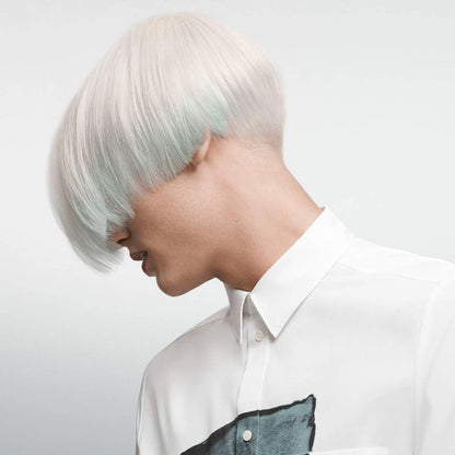 Person with short, pale mint-green hair wearing a white collared shirt.