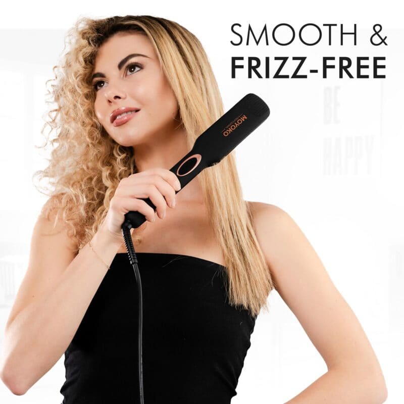 Hair straightening brush held by a woman with blonde hair.