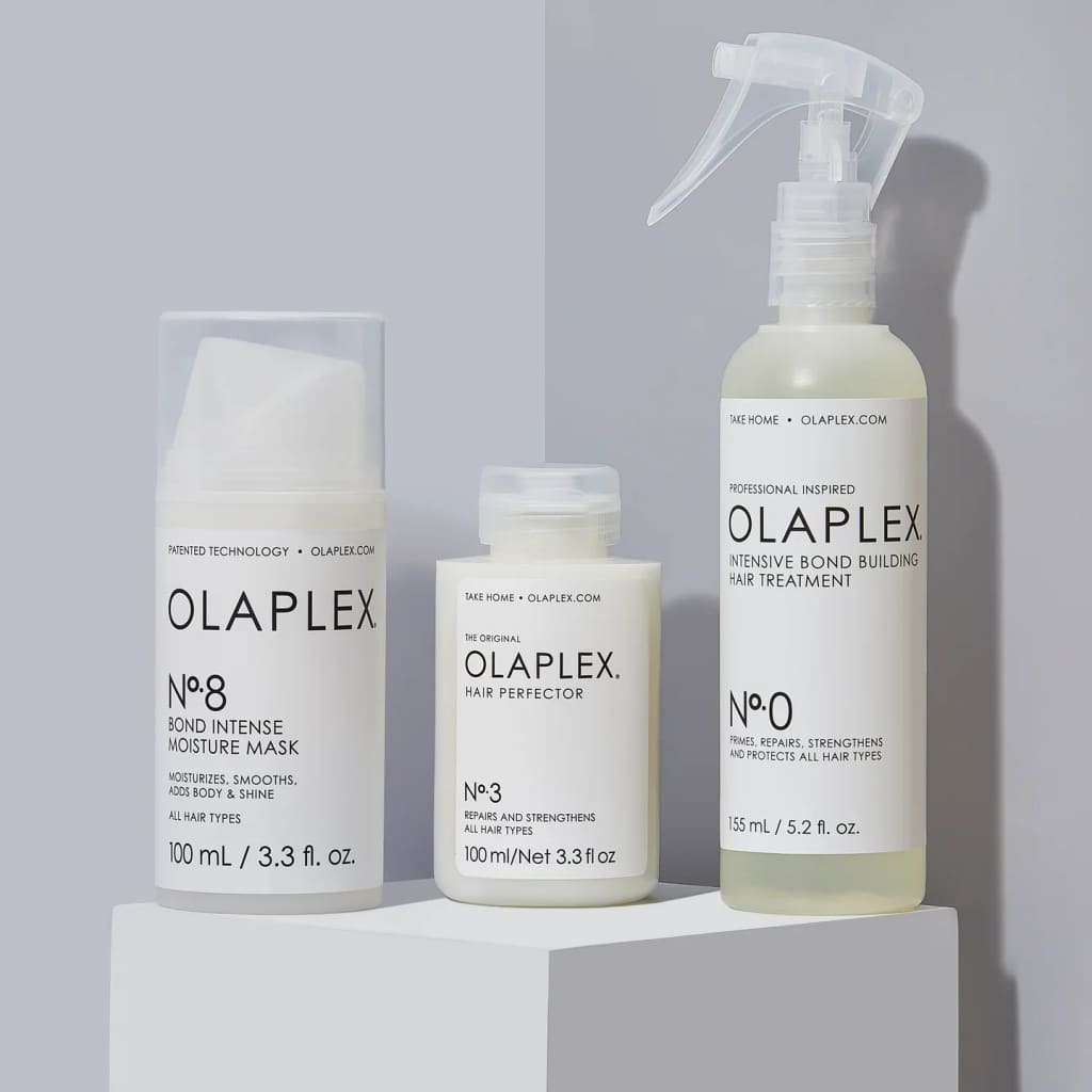 Collection of Olaplex hair care products in white bottles and containers.