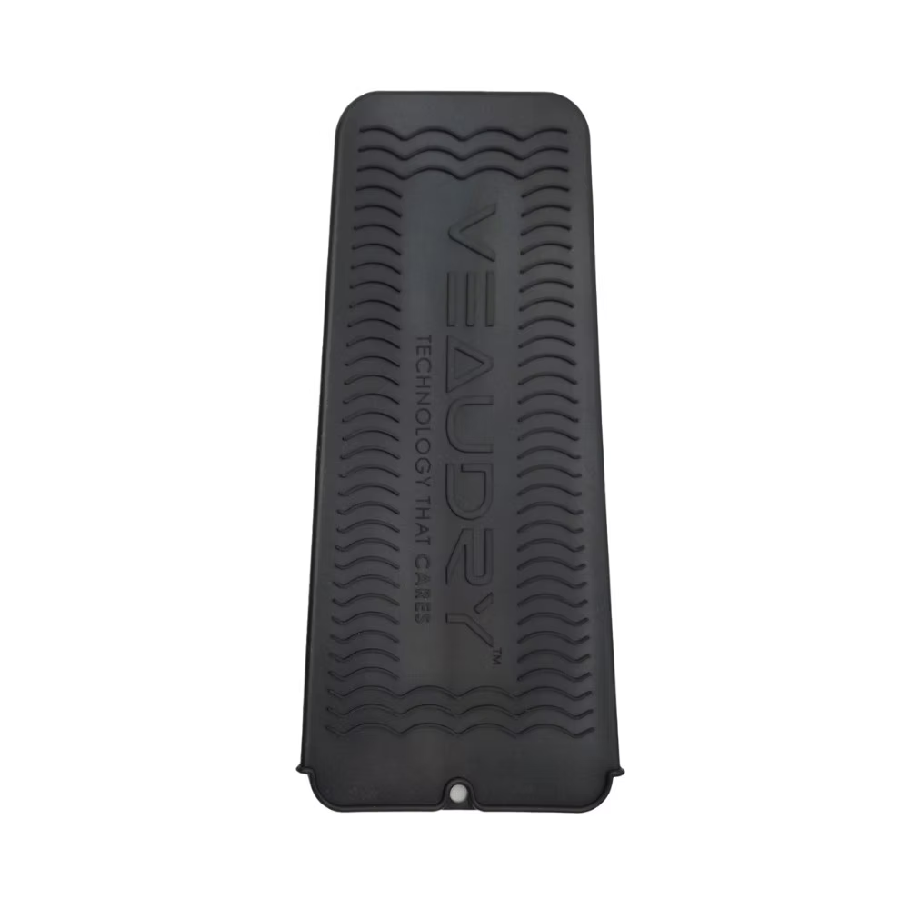 Veaudry Heat Mat Pouch in black with textured silicone surface, ideal for protecting counters from hot hair tools during styling.