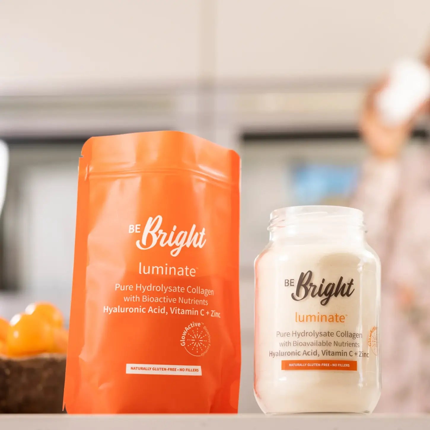 Orange and white containers of The Bright Be Bright Luminate pure hydrolysate collagen 650g