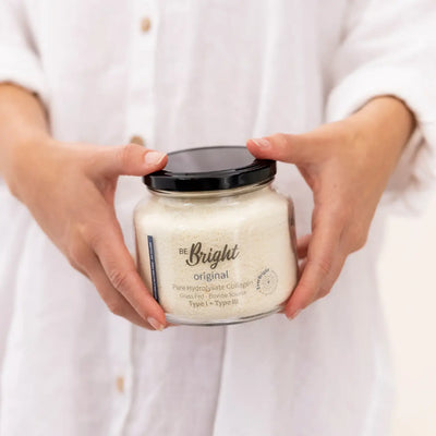 Be Bright Original Pure Collagen Powder 180g in a jar with a golden spoon, showcasing its fine, pure texture.