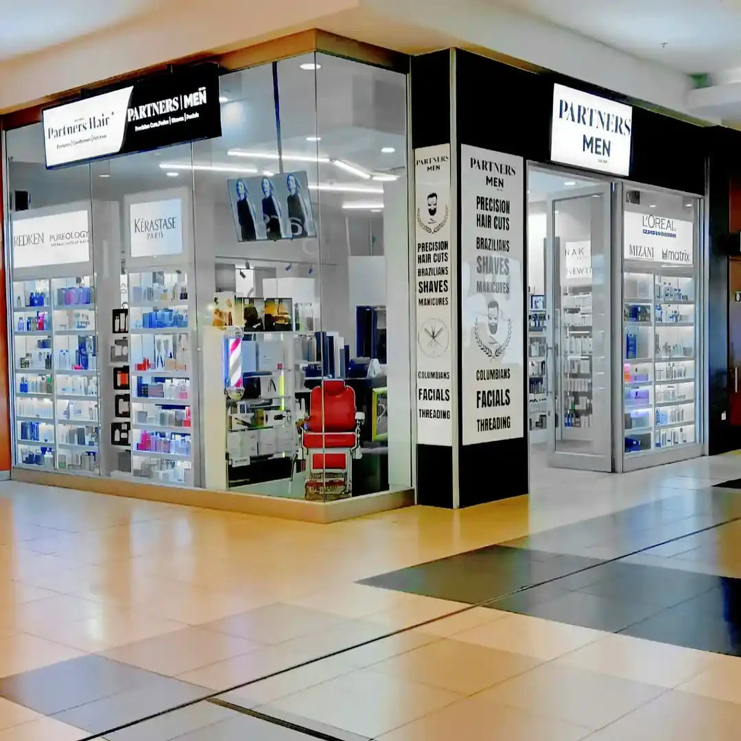 Corner retail store displaying men’s grooming and beauty products.