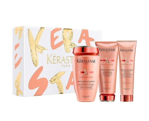 Gift set of Kerastase Discipline Holiday hair care products in pink and gold packaging