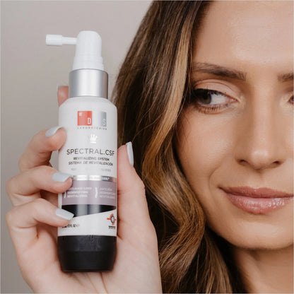 DS Laboratories Spectral Csf 60ml - Hair Loss Solution held by a woman, featuring a revitalizing serum for fuller hair.