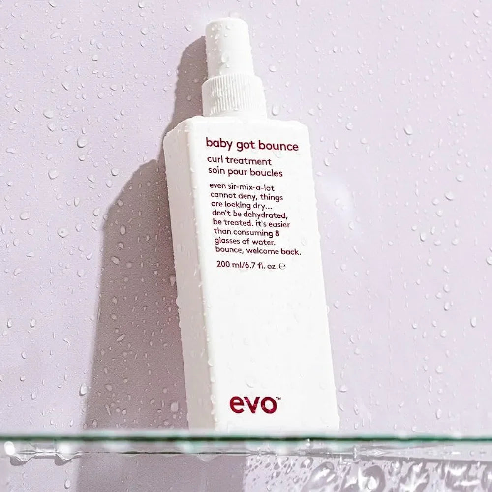 EVO Baby Got Bounce Curl Treatment white spray bottle on wet surface styling aid