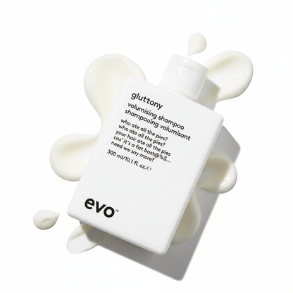 EVO Gluttony Volumising Shampoo bottle with white creamy shampoo swirls on white background