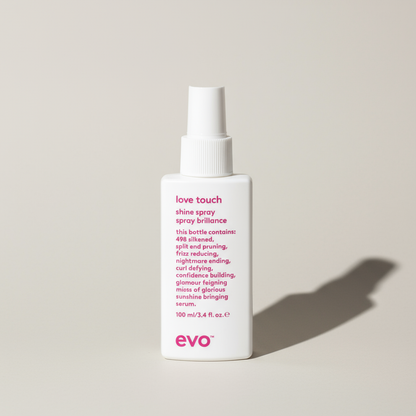 EVO love touch lightweight hair shine spray in white bottle with pink text for styling aid