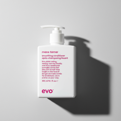 EVO Mane Tamer Smoothing Conditioner bottle with pump dispenser on gray background