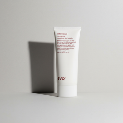 EVO Total Recoil Curl Definer in a white squeeze tube with red text for styling curls
