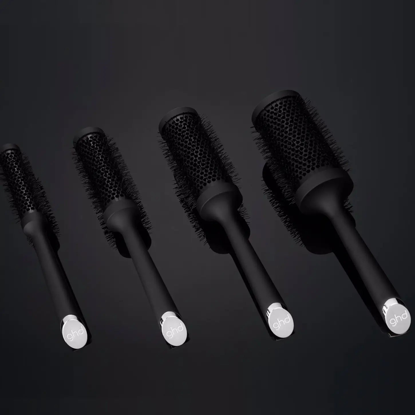 Set of black radial hair brushes with white handles, featuring a 45mm barrel design