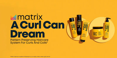 Hair care product line for curly hair featuring yellow bottles and containers.