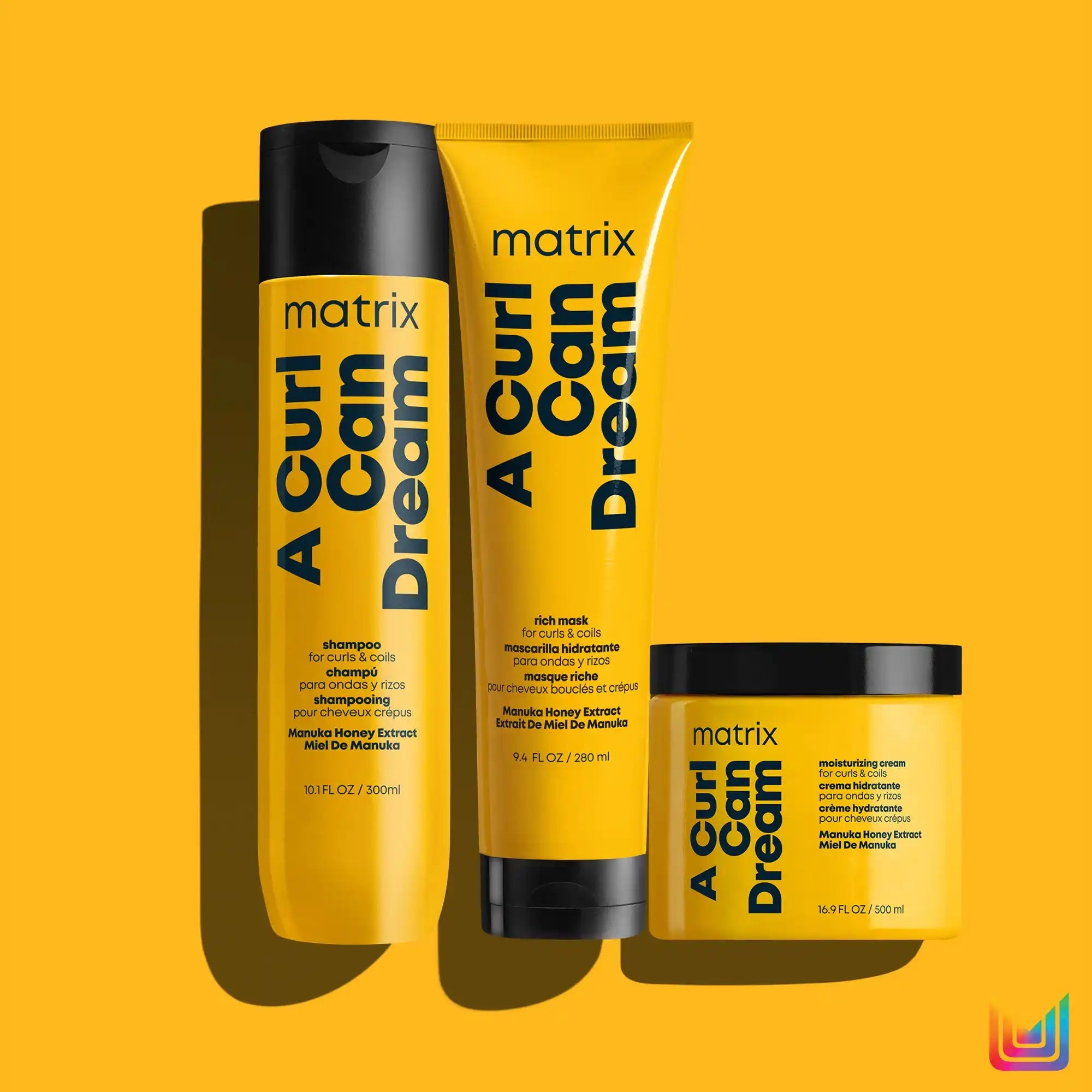 Hair care product line featuring shampoo, conditioner, and treatment in yellow packaging with black text.