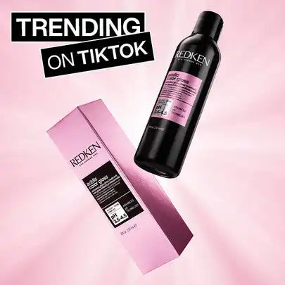 Hair care product from the Redken brand, featuring a black bottle and pink packaging.