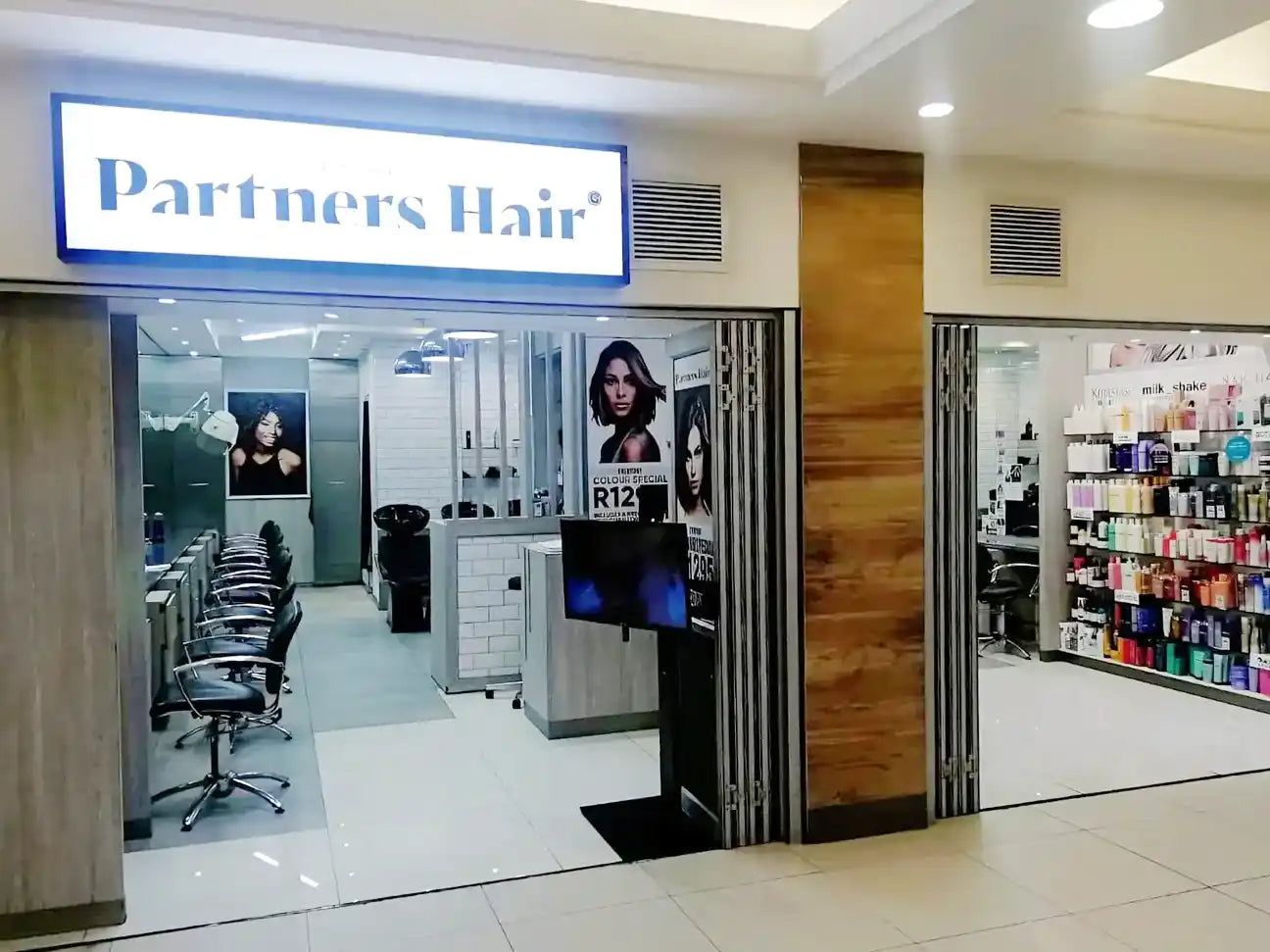 Hair salon storefront with ’Partners Hair’ signage.