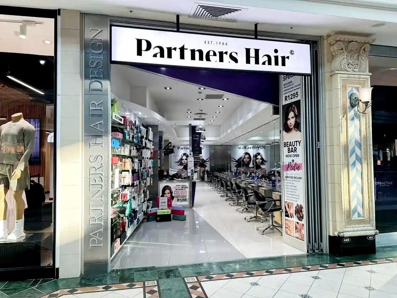 Hair salon storefront with ’Partners Hair’ signage.