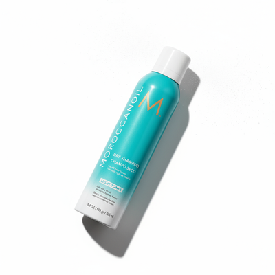 Moroccanoil Dry Shampoo Light Tones spray mist — hold 20-30cm from roots for instant oil absorption and volume