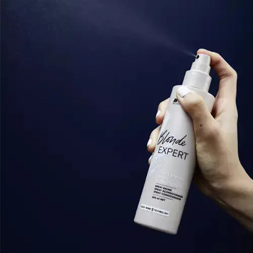Indola Blonde Expert Insta Strong Spray being sprayed: Hair care for blonde hair, strengthens and adds shine